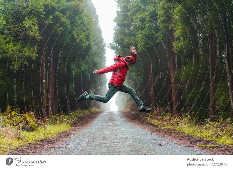 Man jumping on road in forest Tourist Nature bearded Jump Red Jacket Street Lanes & trails Forest Green Vacation & Travel Adventure Landscape Azores Hiking