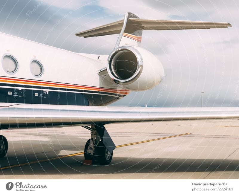 Private luxury jet at the airport terminal Jet Wig Luxury turbine Aviation Engines business class Exclusive Airport Aircraft Airplane Clouds Close-up Copy Space