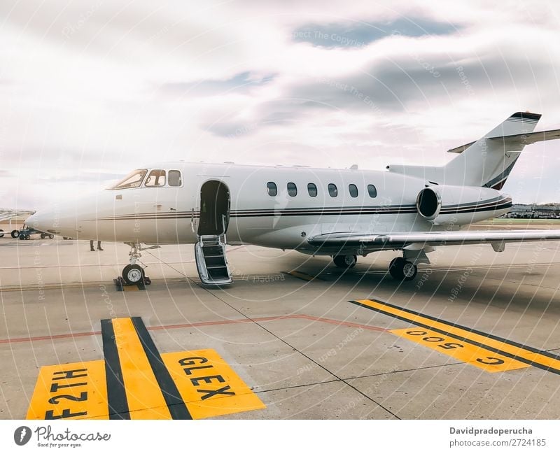 Private luxury jet at the airport terminal Jet Luxury Aviation business class Exclusive Airport Aircraft Airplane Clouds Business Transport Sky Story Runway