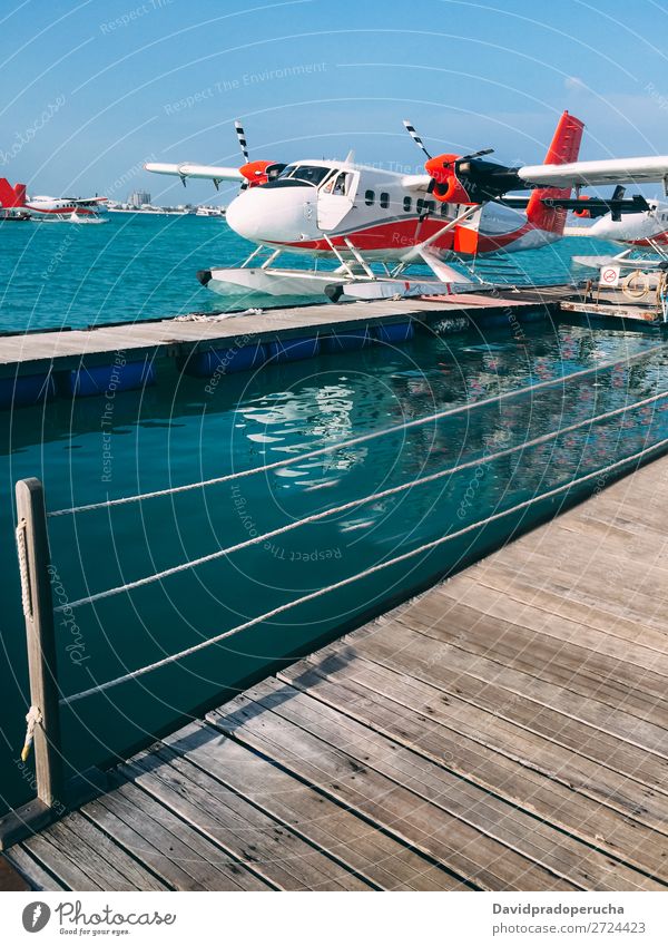 Hydroplane parked at the pier in maldives hydroplane float plane Aircraft Transport Seaplane Jetty Vacation & Travel Float in the water Story Taxi Summer