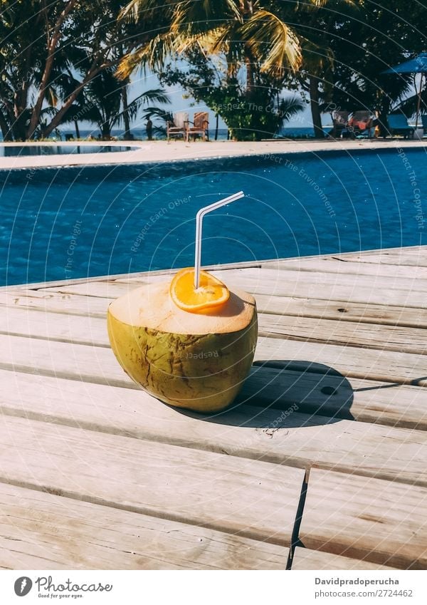 Fresh coconut by the swimming pool Maldives Coconut Orange Fruit Juice Healthy Vacation & Travel Drinking Resort Relaxation Island Idyll Luxury scenery Rest