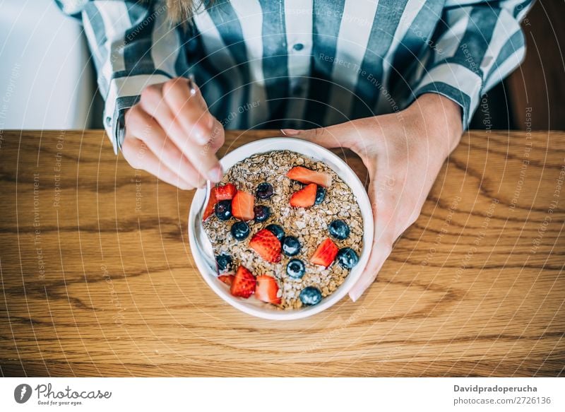 Crop woman close up eating oat and fruits bowl for breakfast Bowl Breakfast Woman Cereal porridge Hand Crops Anonymous Unrecognizable Strawberry Blueberry Oats