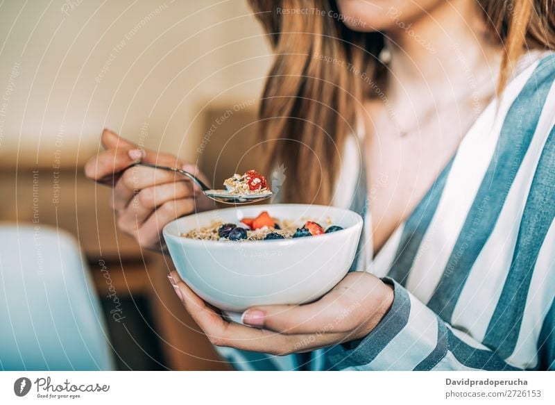 Crop woman close up eating oat and fruits bowl for breakfast Bowl Breakfast Woman Cereal porridge Hand Crops Anonymous Unrecognizable Strawberry Blueberry Oats