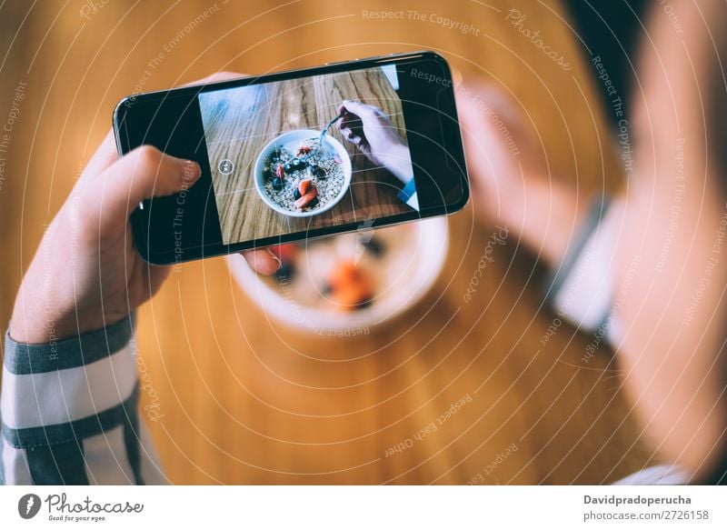 Woman taking photo of a bowl breakfast oats and fruit Photography Shot Mobile PDA Telephone Illustration Take Bowl Strawberry Breakfast Cereal porridge