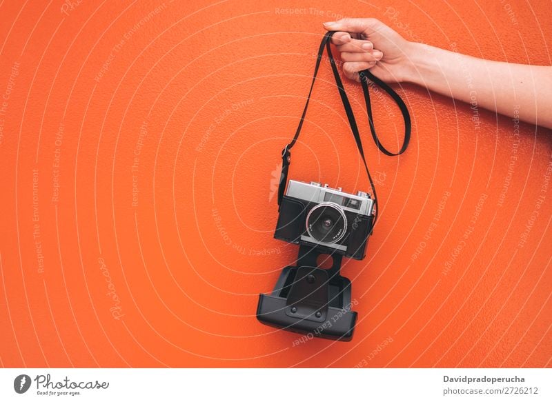 Hand holding a Vintage camera isolated at orange wall Arm Camera Wall (building) Orange Retro Old Isolated Studio shot Hold Leisure and hobbies Illustration