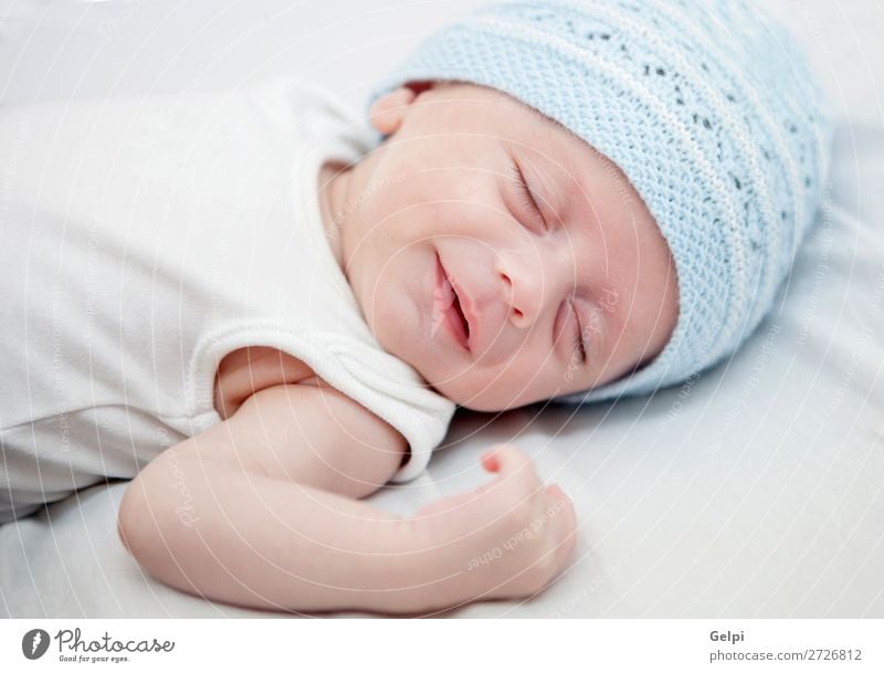 Baby with blue cap sleeping peacefully Lifestyle Joy Happy Beautiful Skin Face Child Human being Toddler Boy (child) Man Adults Infancy Warmth Hat Smiling Sleep