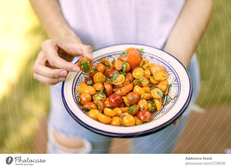 Crop woman holding cooked tomato Woman Plate Snack Tomato Healthy Dinner Meal Food Hold Delicious Nutrition Preparation Organic Cherry Vegetarian diet Vegetable