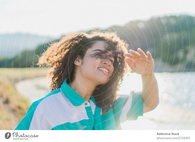 Curly woman posing on nature in sunlight Woman Summer To enjoy Posture human face Landscape Nature Colour Portrait photograph tranquil Exterior shot Countries