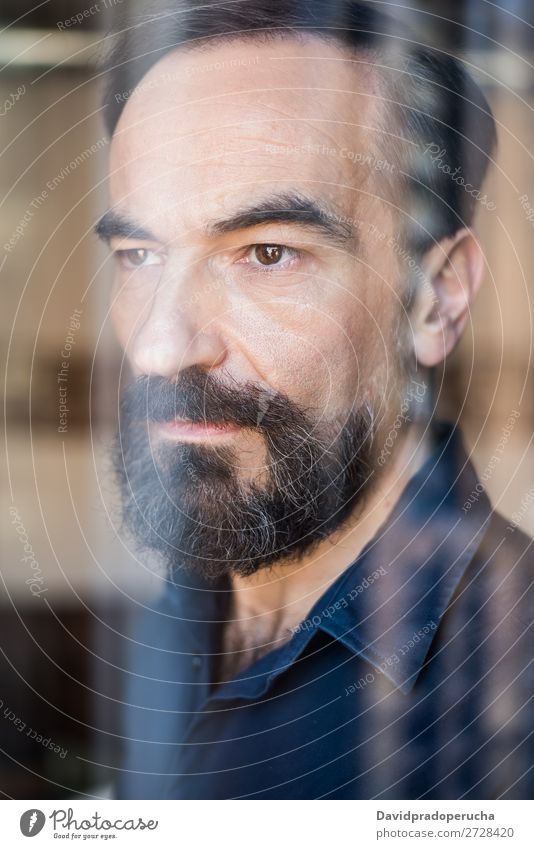 Portrait of a mature man posing thoughtful throughout the window Portrait photograph Man Mature Old Seat Beard Unshaven Considerate Stand Background picture