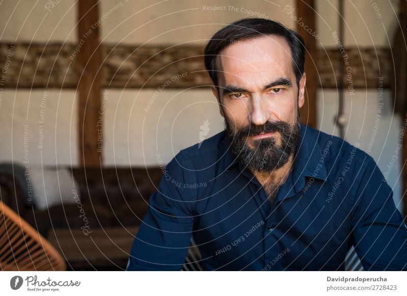 Portrait of a mature man sitting on the chair posing thoughtful Portrait photograph Chair Man Mature Old Seat Beard Unshaven Conceptual design Well Dressed