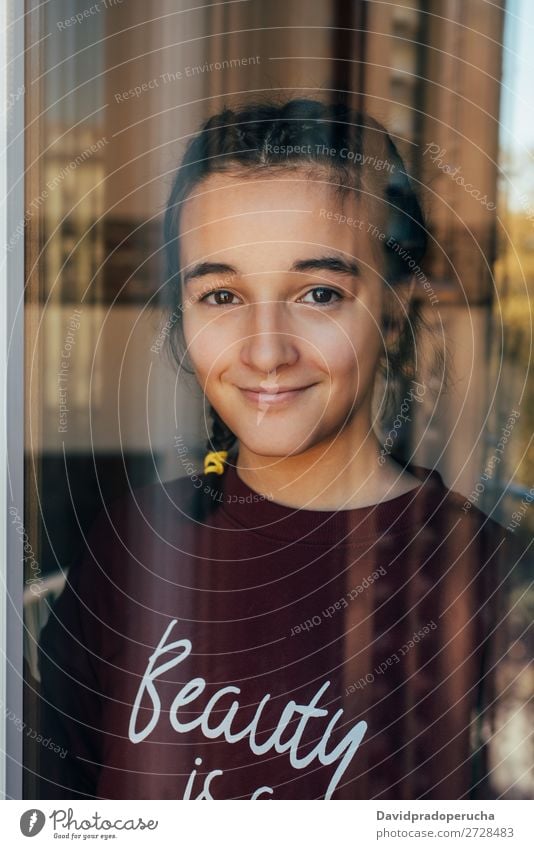Portrait of a young teenager girl standing looking throughout the window Girl Youth (Young adults) Portrait photograph Child Isolated Loneliness Face