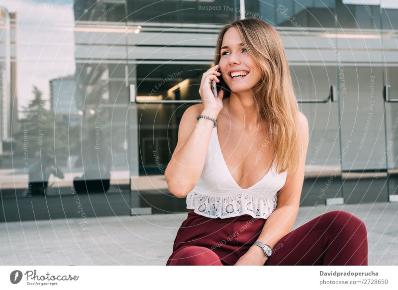 Beautiful young woman sitting in the stairs on the mobile phone Woman Blonde Telephone Mobile Technology Sit Stairs Exterior shot sits Youth (Young adults)
