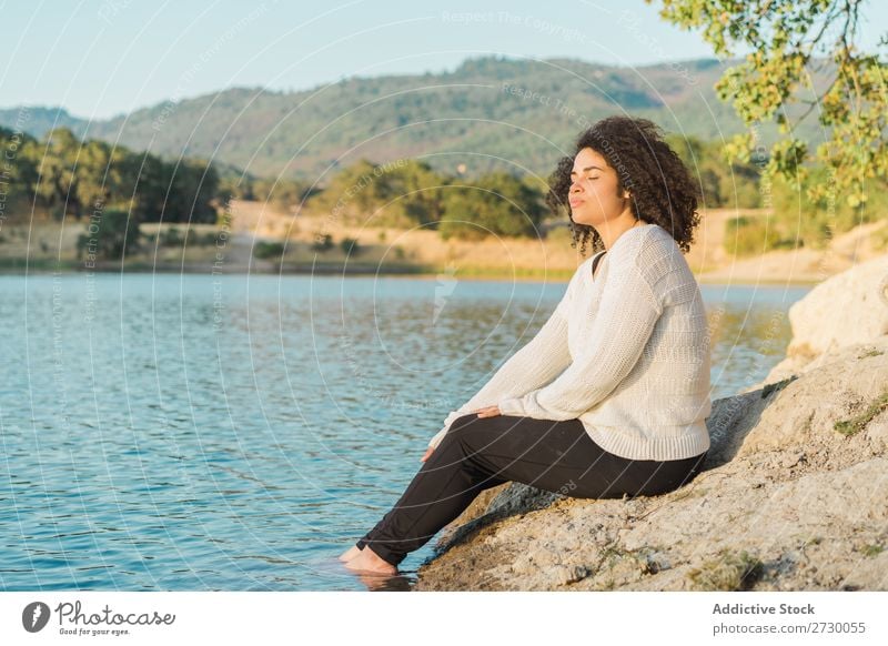 Woman resting at lake Sit Lake Coast Rest eyes closed Stone Rock Nature Water Youth (Young adults) Summer Human being Landscape Loneliness Vacation & Travel