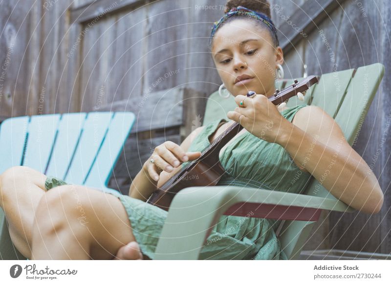 Girl playing ukulele in garden chair Woman Ukulele Musician Garden Relaxation Summer Guitar instrument Beautiful Youth (Young adults) Artist Lifestyle