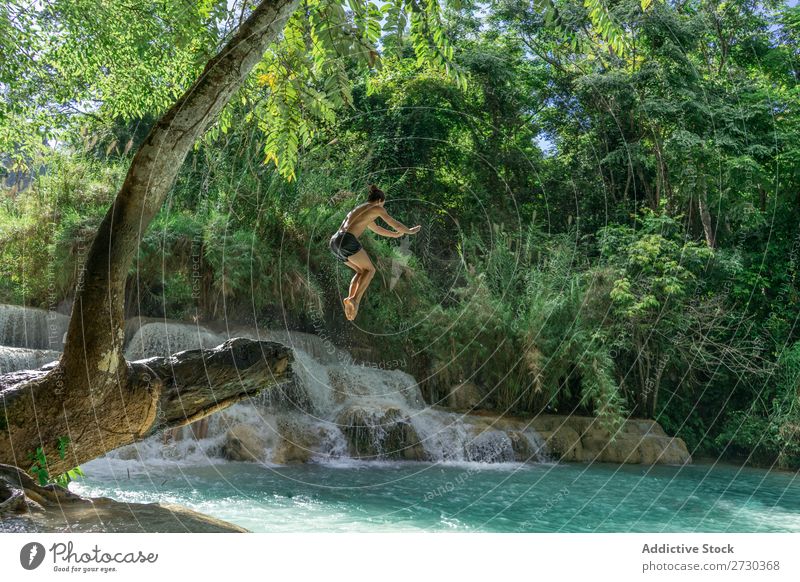 Man jumping to turquoise water Acrobat Nature Extreme Acrobatic shirtless Jump Story mid-air Water Lake Blue Healthy Lifestyle Sports Posture Adventure Strong