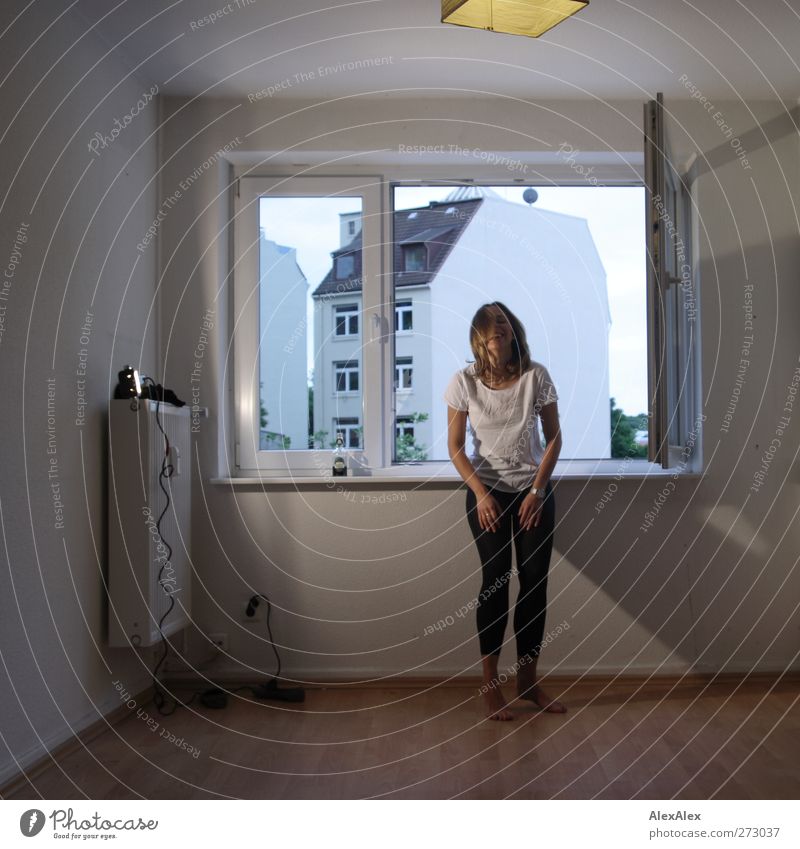 Drum lady - dancer in black leggings and white t-shirt drums on her thighs and stands in empty room at window Style Athletic Dance Practice Steel cable Lamp