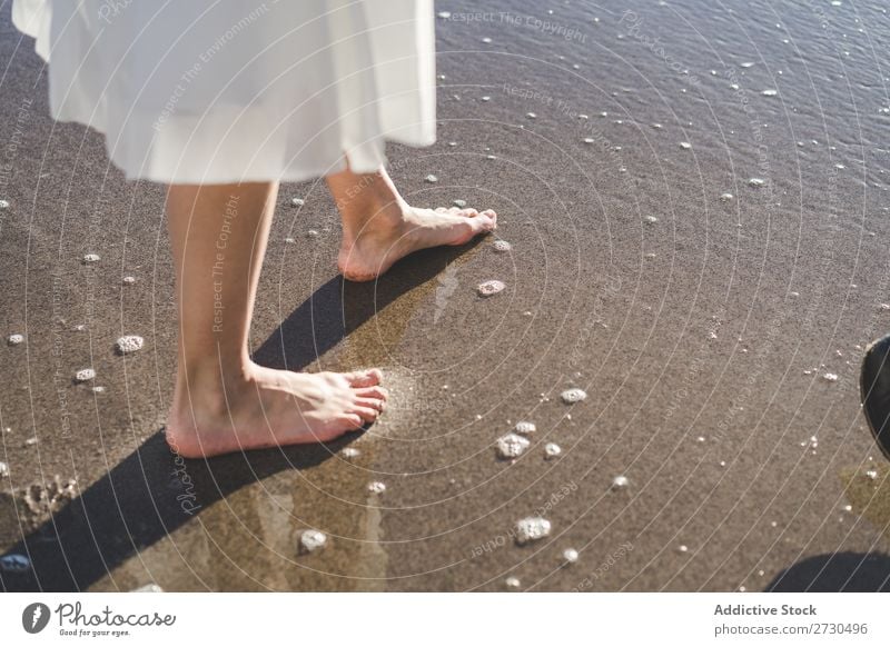 Crop barefoot woman walking on wet sand Woman Bride Barefoot Beach Walking Sand bridal romantic Feet Delicate Leisure and hobbies Ocean Wedding
