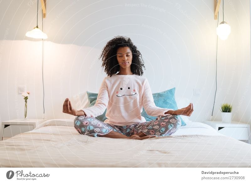 Happy beautiful young black woman relaxed  at home doing morning meditation in bed Woman Black Yoga Meditation Intellect Pyjama pajama Practice Lifestyle