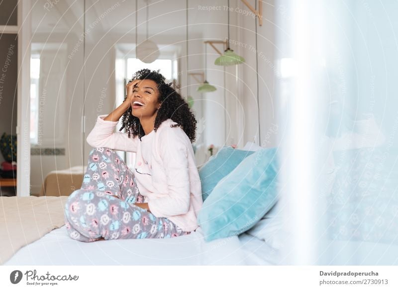 Happy beautiful young black woman relaxed sitting in the bed Woman Black Smiling Relaxation Beautiful awake Cute Bed Cozy Pyjama pajama Winter Cold Sit