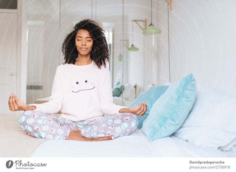 Happy beautiful young black woman relaxed  at home doing morning meditation in bed Woman Black Yoga Meditation Intellect Pyjama pajama Practice Lifestyle