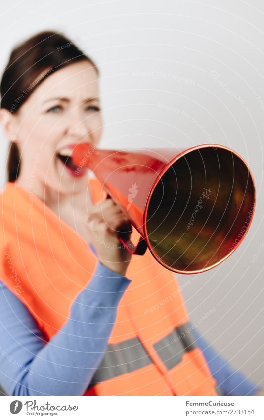 Woman in warning vest making announcement with megaphone Feminine 1 Human being 18 - 30 years Youth (Young adults) Adults 30 - 45 years Communicate Strike