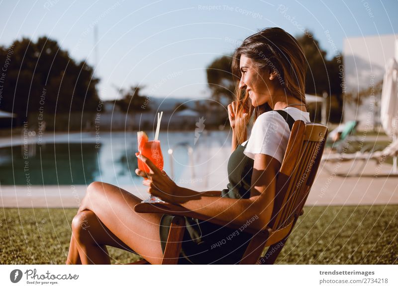 Beautiful woman drinking cocktail near the pool Drinking Juice Alcoholic drinks Lifestyle Happy Swimming pool Vacation & Travel Trip Summer Woman Adults