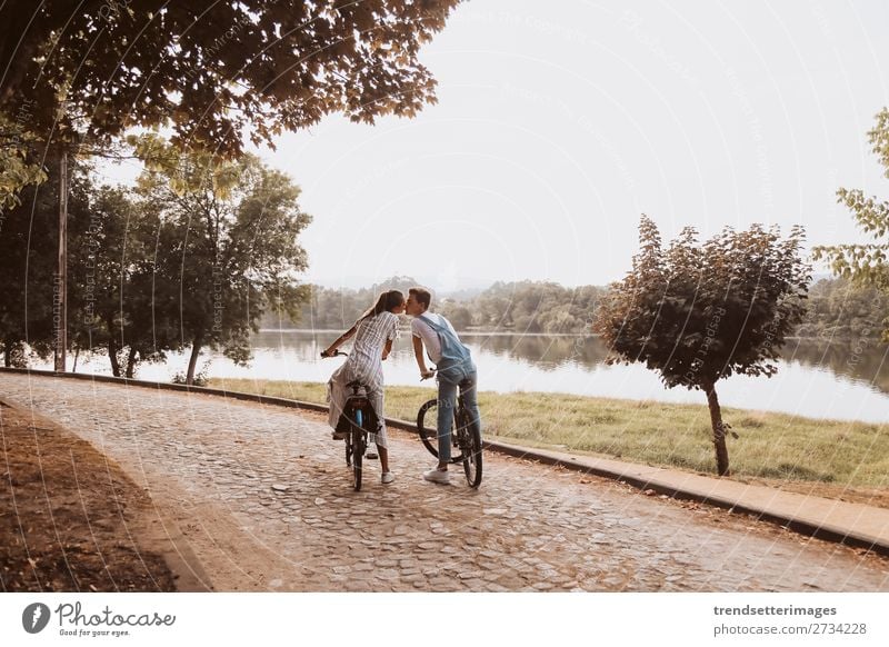 Romantic couple riding bicycles Lifestyle Joy Happy Beautiful Leisure and hobbies Woman Adults Man Family & Relations Couple Nature Landscape Autumn Street