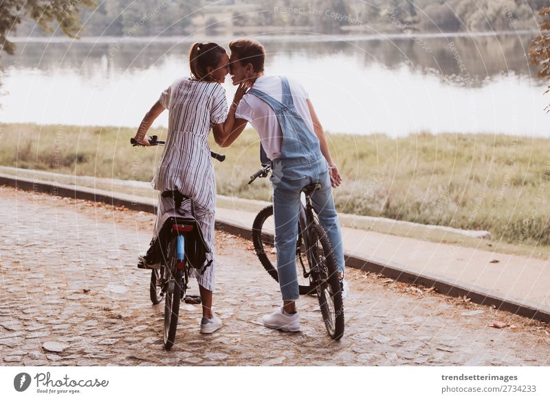 Romantic couple riding bicycles Lifestyle Joy Happy Beautiful Leisure and hobbies Woman Adults Man Family & Relations Couple Nature Landscape Autumn Street