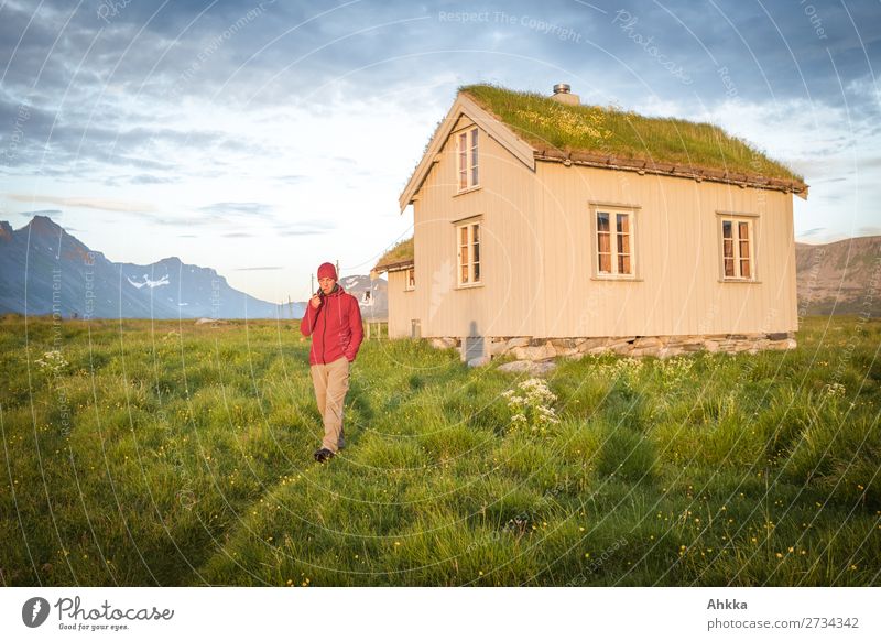 Young man in front of a Norwegian hut in the midnight sun Midnight sun Vacation & Travel Adventure Far-off places Summer vacation Mountain Youth (Young adults)