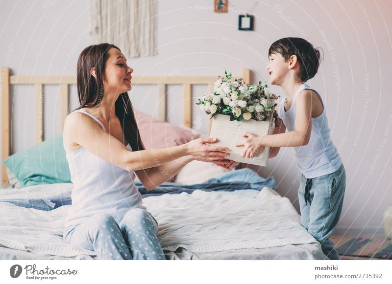 happy child boy giving flowers to mom Lifestyle Joy Happy Playing Bedroom Mother's Day Child Toddler Boy (child) Parents Adults Family & Relations Infancy