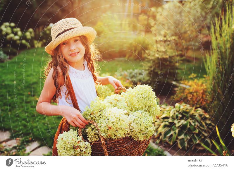 happy romantic kid girl playing and picking flowers Lifestyle Joy Harmonious Leisure and hobbies Summer Garden Child Gardening Environment Nature Landscape