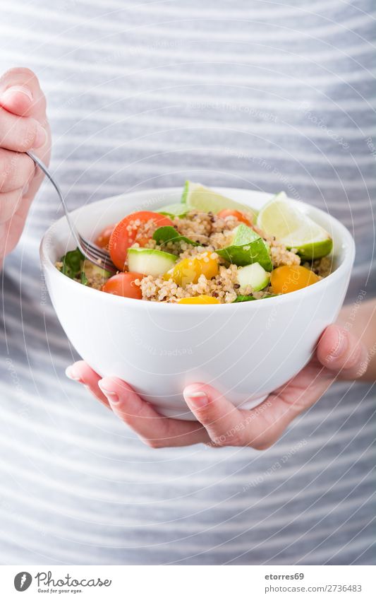 Woman eating quinoa and vegetables in bowl Vegan diet Vegetable Tomato Bowl Vegetarian diet Healthy Healthy Eating Diet Grain Preparation superfood Seed gluten