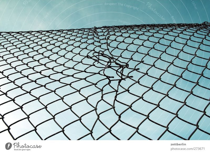 wire mesh fence Sky Cloudless sky Spring Summer Town Outskirts Aggression Pain Longing Homesickness Wanderlust Wire netting fence Fence Border Real estate