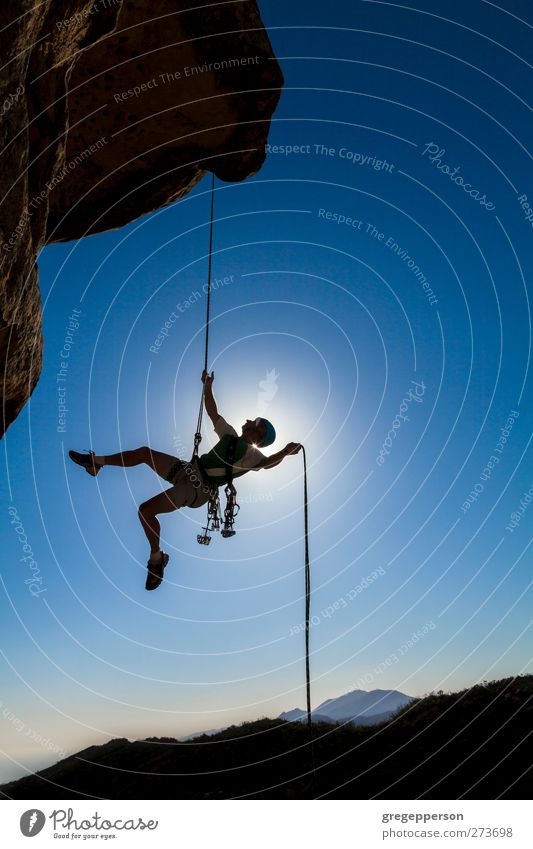 Climber on a free rappel. Fitness Life Adventure Mountain Climbing Mountaineering Rope Masculine Man Adults 1 Human being Rock Peak Hang Blue Bravery