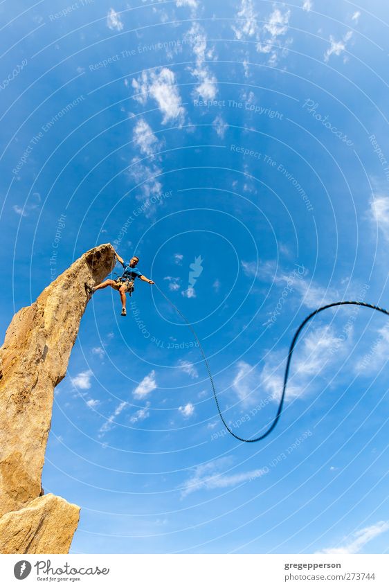 Climber dangles from the summit. Life Adventure Climbing Mountaineering Success Rope Masculine Man Adults 1 Human being Rock Peak Hang Blue Self-confident Power