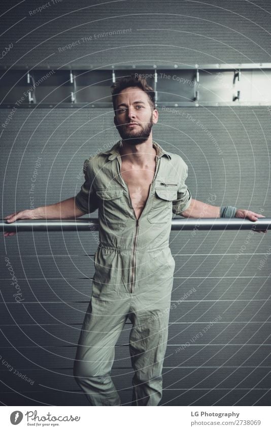 Portrait of a man in a jumpsuit Beautiful Body Calm Masculine Homosexual Man Adults Building Fashion Beard Metal Simple Eroticism Modern Gray White hair Khaki