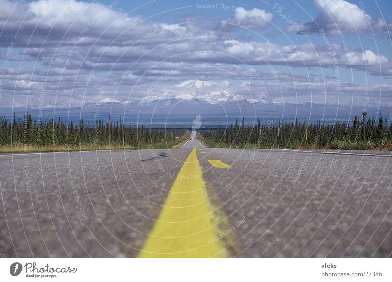Road to the mountain Clouds Yellow Stripe Asphalt Street Mountain Sky Blue Clouds in the sky Central perspective Median strip Lane markings Landscape