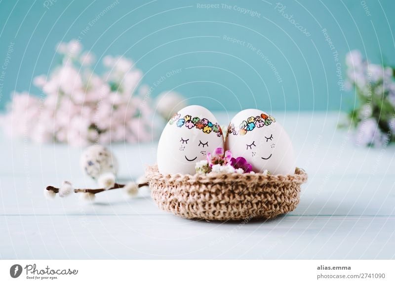 OSTERkuschelEI - 2 sweet Easter eggs lie in the Easter nest Egg Blue Face Beautiful Painted Easter egg nest Copy Space Easter wish Easter gift Card Spring