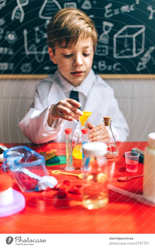 Boy playing with chemistry game Playing Science & Research Child School Blackboard Laboratory Human being Boy (child) Man Adults Tie Think Smart Interest