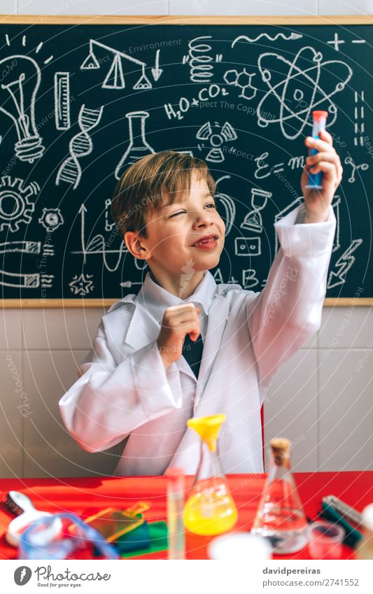 Boy playing with chemistry game Playing Science & Research Child Blackboard Laboratory Human being Boy (child) Man Adults Think Smart Considerate Chemist