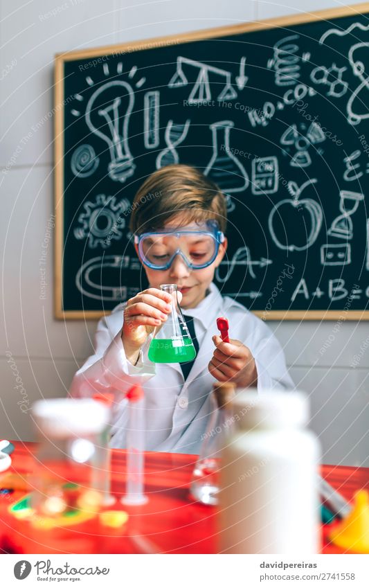 Boy playing with chemistry game Playing Science & Research Child School Blackboard Laboratory Human being Boy (child) Man Adults Tie Think Smart Interest