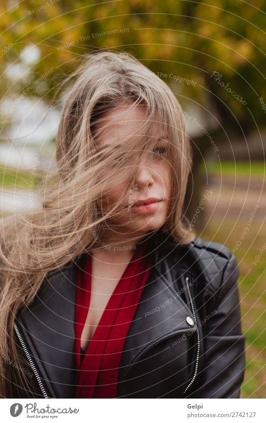 Pretty blonde girl with leather jacket in the street Lifestyle Happy Beautiful Face Freedom Human being Woman Adults Nature Autumn Wind Tree Park Street Fashion