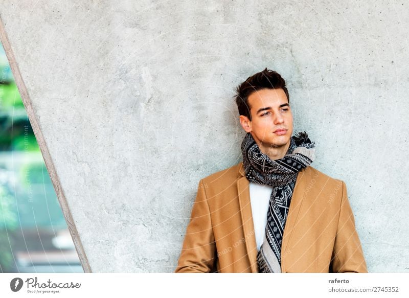 Young man wearing coat leaning on a wall while looking away Lifestyle Elegant Style Beautiful Hair and hairstyles Human being Masculine Youth (Young adults) Man