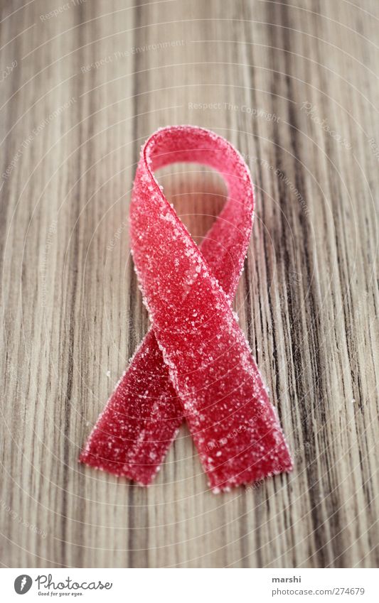 symbolic power Food Candy Nutrition Sign Red Symbols and metaphors Symbolism AIDS aid loop Bow World AIDS Day Illness Sweet Beautiful Colour photo Detail