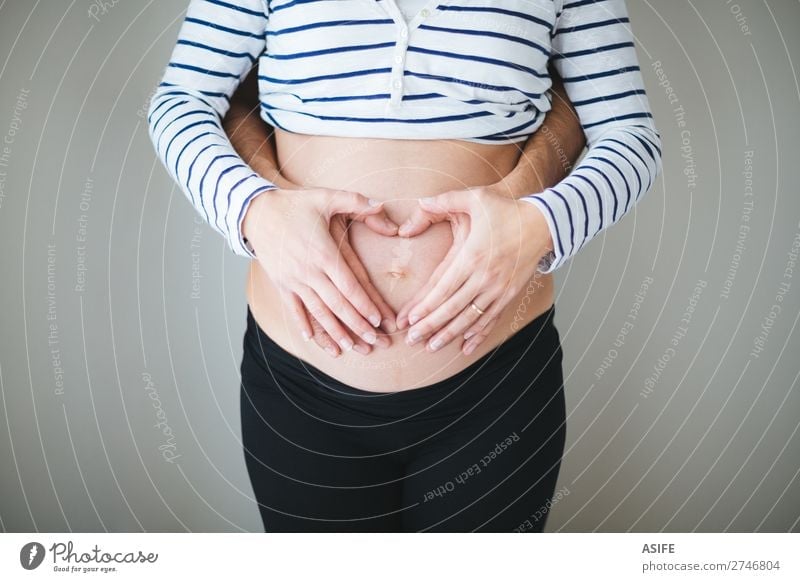Heart wirh couple hands on the pregnant belly Happy Beautiful Body Baby Woman Adults Man Parents Mother Father Family & Relations Couple Hand Touch Love Stand
