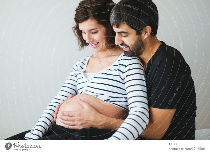 Happy pregnant couple feeling the movements of their baby Beautiful Body Baby Woman Adults Man Parents Mother Father Family & Relations Couple Touch Smiling