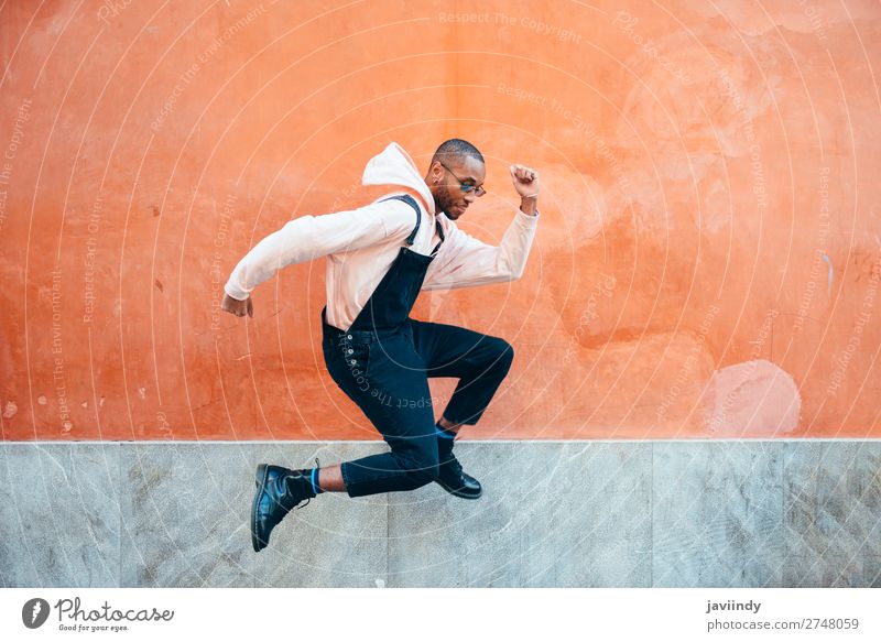 Young black man wearing casual clothes jumping in urban background Lifestyle Joy Happy Beautiful Human being Masculine Young man Youth (Young adults) Man Adults