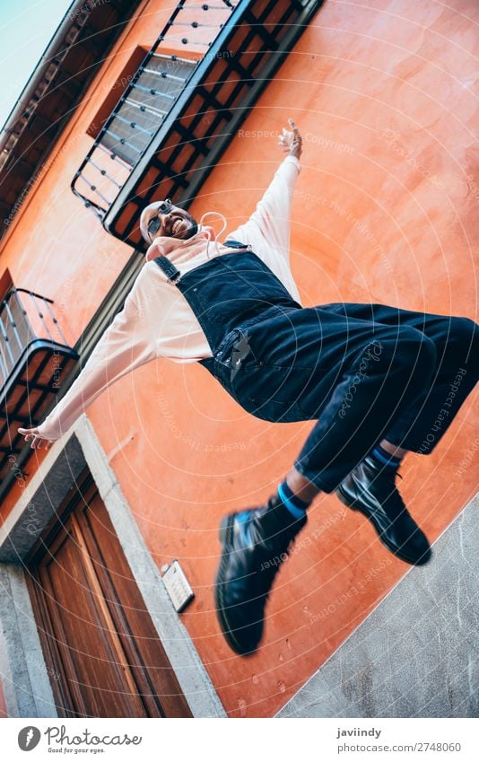 Young black man wearing casual clothes jumping outdoors Lifestyle Joy Happy Beautiful Human being Masculine Young man Youth (Young adults) Man Adults 1