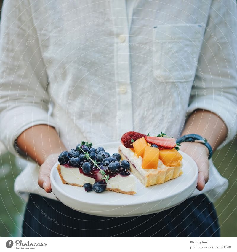 Close up woman hands holding plate of pie Cheese Fruit Dessert Plate Summer Restaurant Woman Adults Hand Fresh Delicious White background Bakery Blueberry Café