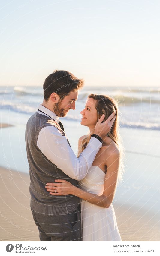 Tender kissing bridal couple in sunlight Couple Wedding Beach Sunlight embracing Engagement Contentment valentine enjoyment in love seascape Stand Relationship